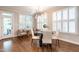 Elegant dining area with large windows and modern lighting, featuring hardwood floors and a cozy seating arrangement at 1313 Dale St, Raleigh, NC 27605