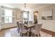 Bright dining room featuring a modern chandelier and a rustic wooden table, enhanced by natural light and elegant decor at 1313 Dale St, Raleigh, NC 27605