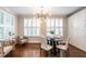 Modern dining room with bright windows, hardwood floors, and stylish decor, creating an inviting and elegant atmosphere at 1313 Dale St, Raleigh, NC 27605