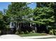 Two-story home featuring a front porch, mature trees, lush landscaping, and a well-maintained lawn at 1313 Dale St, Raleigh, NC 27605