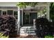 Inviting front porch with ceiling fan, steps, and classic columns, enhanced by lush greenery at 1313 Dale St, Raleigh, NC 27605