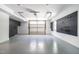Spacious garage with epoxy floors, overhead door, and custom wall-mounted storage at 1313 Dale St, Raleigh, NC 27605