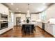 Spacious kitchen featuring an island with seating, modern appliances, and custom cabinets, perfect for cooking and entertaining at 1313 Dale St, Raleigh, NC 27605