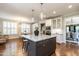 Open-concept kitchen with a large island, modern appliances, and ample cabinet space, flowing into an adjacent dining area at 1313 Dale St, Raleigh, NC 27605
