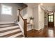 Elegant staircase with hardwood steps, white risers, and a decorative table, offering a stylish transition at 1313 Dale St, Raleigh, NC 27605