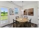 Cozy dining area with modern decor, a pendant light, and an access door to the backyard at 140 Camel Crazies Pl # 39, Lillington, NC 27546