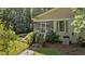 Charming screened-in back porch with stairs and lush greenery, perfect for relaxing outdoors at 191 Nc 56, Louisburg, NC 27549