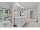 Large bathroom featuring a double vanity, shower, toilet, and natural light from the window at 191 Nc 56, Louisburg, NC 27549