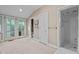 Spacious bathroom featuring double French doors, a walk-in shower and a white door to the water closet at 191 Nc 56, Louisburg, NC 27549