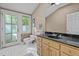 Functional bathroom featuring a toilet, sink with vanity, and a bright window at 191 Nc 56, Louisburg, NC 27549