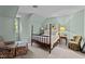 Charming bedroom with an antique four-poster bed, neutral carpet, and natural light at 191 Nc 56, Louisburg, NC 27549