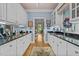 Butler pantry with black granite countertops and ample cabinet storage space at 191 Nc 56, Louisburg, NC 27549