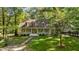 Beautiful home surrounded by lush greenery and mature trees at 191 Nc 56, Louisburg, NC 27549