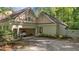 Spacious garage featuring an open door, driveway, and stylish architectural details at 191 Nc 56, Louisburg, NC 27549