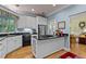 Kitchen with white cabinets, black counters, and stainless steel appliances at 191 Nc 56, Louisburg, NC 27549