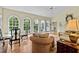 Inviting living area filled with light from arched windows, featuring wicker seating and hardwood floors at 191 Nc 56, Louisburg, NC 27549