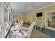 Relaxing screened-in porch with comfortable seating and ceiling fans at 191 Nc 56, Louisburg, NC 27549