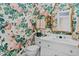 Charming powder room featuring floral wallpaper and elegant fixtures at 191 Nc 56, Louisburg, NC 27549