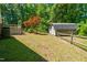 Backyard featuring a wooden fence, mature trees, shed and outdoor seating area, ideal for entertaining at 2100 Fort Dr, Clayton, NC 27520