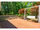 Spacious wooden deck with railing and a swing seat, ideal for relaxing and enjoying the outdoor view at 2100 Fort Dr, Clayton, NC 27520