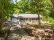 Quaint single-story home with a welcoming front porch, attached garage and a mature tree-lined yard at 2100 Fort Dr, Clayton, NC 27520