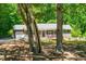 Charming single-story home with a gray exterior, blue shutters, a well-manicured lawn, and mature trees at 2100 Fort Dr, Clayton, NC 27520