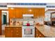 Close-up of kitchen with wood cabinets and decorative tile backsplash at 2100 Fort Dr, Clayton, NC 27520