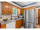 Spacious kitchen area featuring wood cabinets, countertops, and stainless refrigerator at 2100 Fort Dr, Clayton, NC 27520
