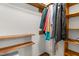Walk-in closet featuring wooden shelves and hanging clothing at 2100 Fort Dr, Clayton, NC 27520