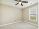 Carpeted bedroom with natural lighting and a ceiling fan at 217 Braxcarr St, Holly Springs, NC 27540