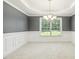 Dining room with chair rail, large window, and chandelier at 217 Braxcarr St, Holly Springs, NC 27540