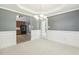 Dining room with chair rail, modern chandelier, and archway leading to the kitchen at 217 Braxcarr St, Holly Springs, NC 27540