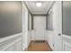 Inviting entryway features wainscoting, hardwood floors, and neutral wall color at 217 Braxcarr St, Holly Springs, NC 27540