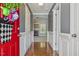View of a foyer with hardwood floors and a fireplace in the adjacent living room at 217 Braxcarr St, Holly Springs, NC 27540