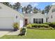 Charming one-story home features a red front door, and manicured lawn at 217 Braxcarr St, Holly Springs, NC 27540