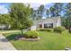 View of a quaint one-story home with a manicured lawn at 217 Braxcarr St, Holly Springs, NC 27540