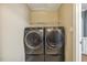 Modern laundry room boasts a sleek washer and dryer set with handy wire shelving for storage at 217 Braxcarr St, Holly Springs, NC 27540