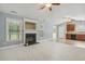 Bright living area with a fireplace, modern fixtures, and seamless flow into the kitchen area at 217 Braxcarr St, Holly Springs, NC 27540