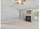 Bright living room features a modern fireplace and light-colored carpeting at 217 Braxcarr St, Holly Springs, NC 27540