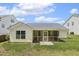 Rear view showcases a lovely screened porch and neat landscaping enhancing the home's curb appeal at 217 Braxcarr St, Holly Springs, NC 27540