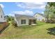 Back of house view featuring a charming screened porch and a well-manicured lawn at 217 Braxcarr St, Holly Springs, NC 27540