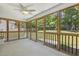 Enjoy this cozy screened-in porch offering a relaxing outdoor space with a ceiling fan at 217 Braxcarr St, Holly Springs, NC 27540