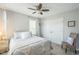 Bright bedroom featuring closet, ceiling fan, and a window dressed with neutral-toned curtains at 221 Mayfield Dr, Apex, NC 27539