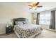 Bedroom with neutral walls featuring a ceiling fan, closet, and a window bringing in ample light at 221 Mayfield Dr, Apex, NC 27539
