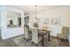 Elegant dining room featuring stylish seating, decorative artwork, and seamless access to the kitchen at 221 Mayfield Dr, Apex, NC 27539