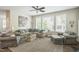 Comfortable living room featuring ample seating, neutral colors, and large windows for natural light at 221 Mayfield Dr, Apex, NC 27539