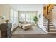 Inviting living room with plush seating, abundant natural light, and staircase access at 221 Mayfield Dr, Apex, NC 27539