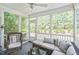 Relaxing screened porch with comfortable seating, ceiling fan, and views of the private backyard at 221 Mayfield Dr, Apex, NC 27539