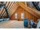 Unfinished attic featuring exposed rafters, two windows, black air ducts and blue storage containers at 24 Sweet Birch Row, Youngsville, NC 27596