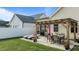 Backyard view featuring a pergola-covered patio, lounge chairs, dining set, and landscaped yard with a white fence at 24 Sweet Birch Row, Youngsville, NC 27596
